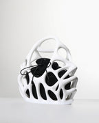 White and black geometric vase on a white background