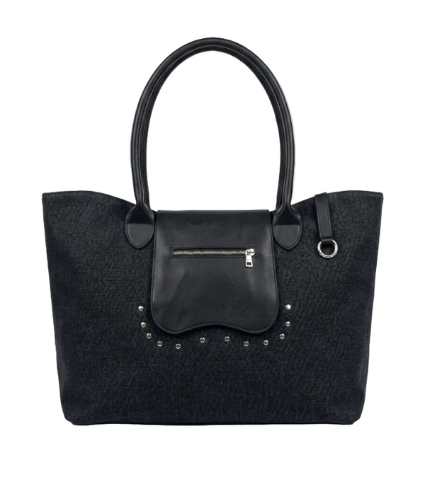 A black textured tote bag with a smooth black leather front flap pocket, silver-tone zipper, and decorative silver studs, shown against a light gray background.
