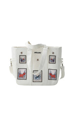 Omashu white tote bag with embroidered patches and laptop divider, featuring bold, street-style graphics.