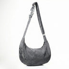 Gray shoulder bag with decorative handle on a white background